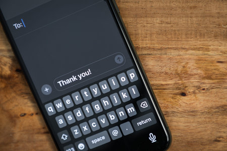 A phone with a keyboard on it that says thank you on it ready to send a message