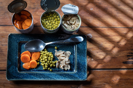 Servings of canned vegetables on a plate as a concept for National Canned Food Day.の写真素材