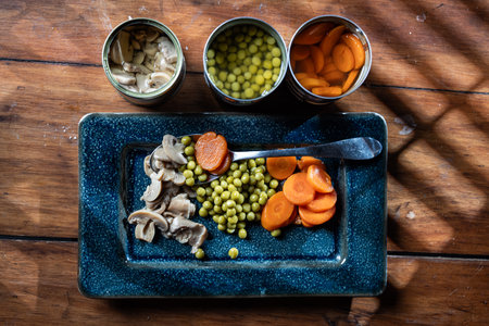 Servings of canned vegetables on a plate as a concept for National Canned Food Day.の写真素材
