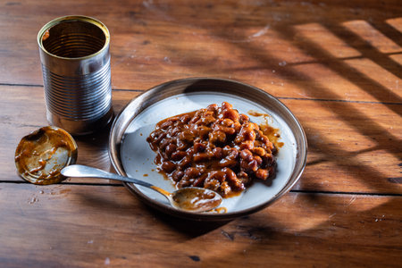 A can and a plate with beans on it ready to be devouredの写真素材