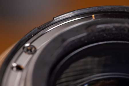 Macro image of a damaged rubber weather seal on a pro lens in need of repair.