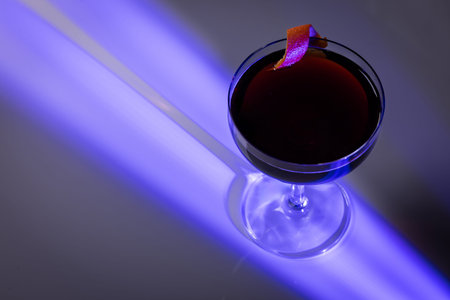 Top View of a Black Espresso Martini with Orange Twist and Dramatic Shadow Lighting