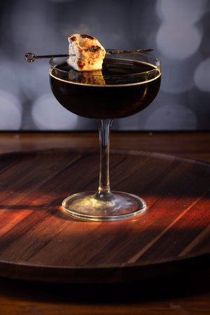 Dark Espresso Martini with Toasted Marshmallow Served on a Ceramic Plate