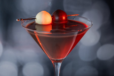 A close-up side profile of a chocolate cocktail in a coupe glass, garnished with a dark and white...
