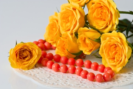 Yellow roses and coral beadsの写真素材