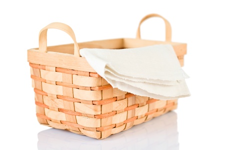 Wicker basket and napkin isolated on white backgroundの写真素材