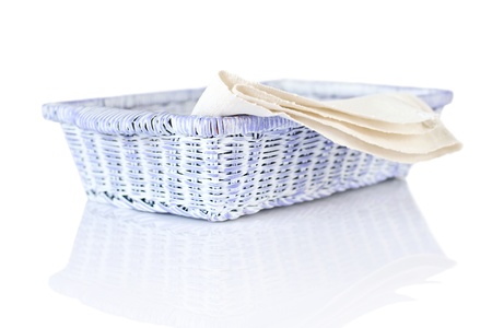 Wicker basket and napkin isolated on white backgroundの写真素材