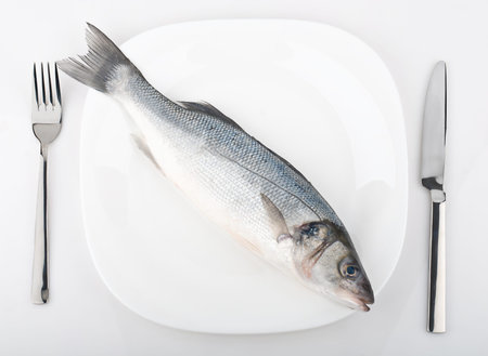 Fresh fish on plate isolated on white