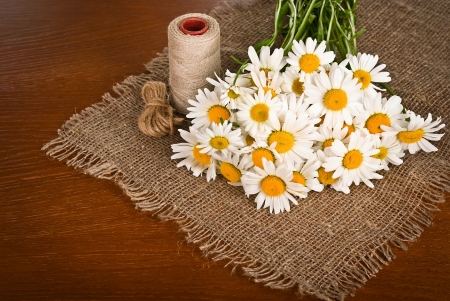 Fresh chamomile flowers on the wooden tableの写真素材