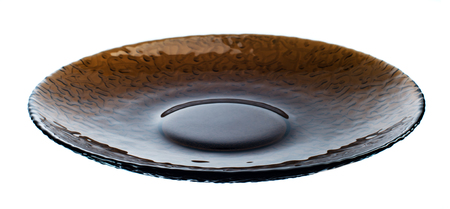 Single dark transparent plate isolated on white backgroundの写真素材