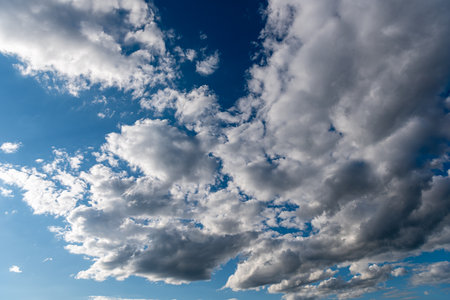 white fluffy clouds in the blue skyの写真素材