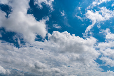 white fluffy clouds in the blue skyの写真素材