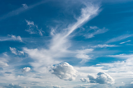 white fluffy clouds in the blue skyの写真素材