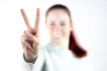 young women makes victory signの写真素材