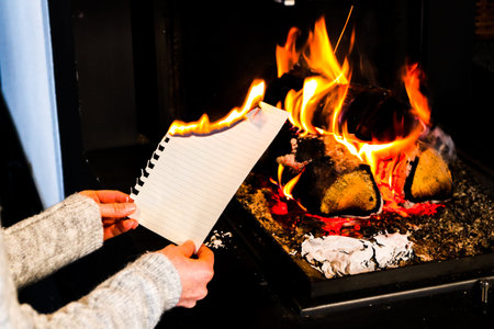 young women burns a sheet of paperの写真素材