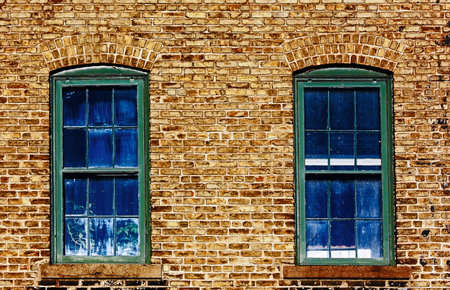 Two Blue Windows on an old Brice Wall