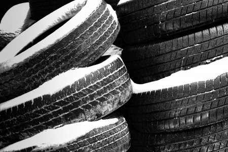 Stacks of Worn Tires in the Snow.の写真素材