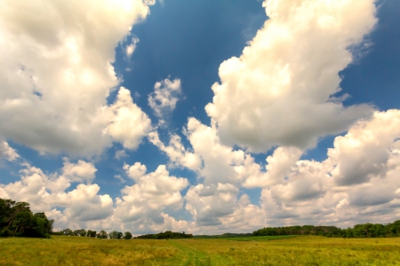 Big Sky of Puffy Cumulus Clouds Over the Countrysideの写真素材