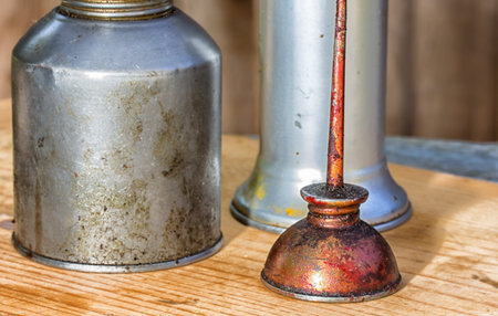 Three Oil Cans of Differing Sizes and Color Macroの写真素材