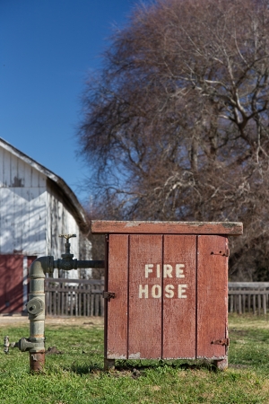 Old Fashioned Fire Hose Box Vertical Image on Rural Farm in the United Statesの写真素材