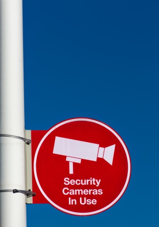 Red Security Cameras in Use Sign in American Mall Parking Lot in Verticalの写真素材