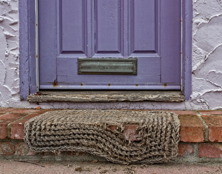 Purple Door with Worn Rug and Venetian Stucco Textured Wallの写真素材
