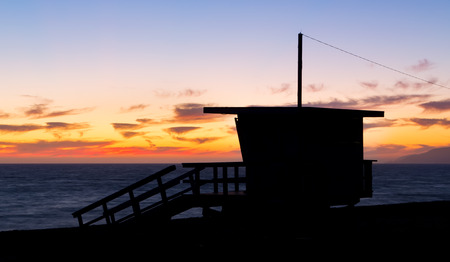 Lifeguard stand at dusk in silhouette at Zuma Beach in Malibu, California.の写真素材