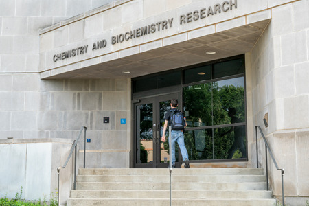 FAYETTEVILLE, AR/USA - JUNE 8, 2018: Unidentified individual and Chemistry and Biochemistry Research Building at University of Arkansas.のeditorial素材