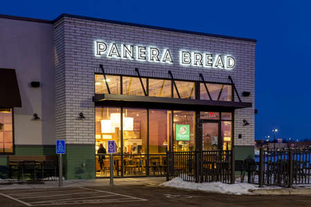 BAYPORT, MN/USA - FEBRUARY 22, 2020: Panera Bread restaurant exterior at twighlight and trademark logo.のeditorial素材