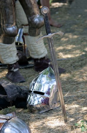 Sword will thrust beside with a helmet laying on the groundの写真素材