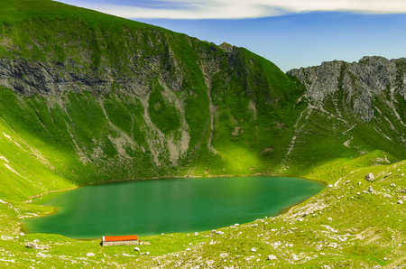 Idyllic lake alongside the hiking trail between the Nebelhorn and the Giebelhaus.の写真素材