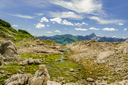 A creek is crossing a walking track in the alps.の写真素材