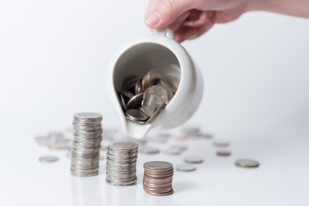 hand putting coin on white background, Saving moneyの写真素材