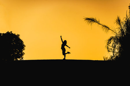 woman or businesswoman silhouette jump happy on the roadの写真素材