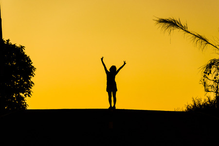 woman or businesswoman silhouette jump happy on the roadの写真素材