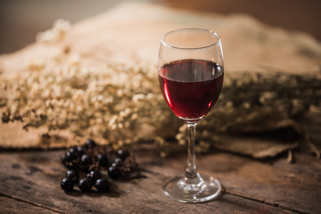 Glass of red wine and grapesの写真素材