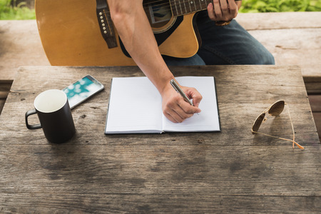 man compose song and play guitarの写真素材