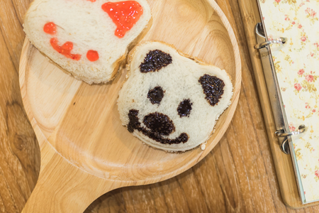 panda on toasted bread on wood tableの写真素材