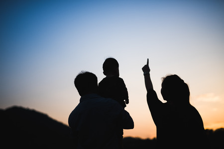 silhouette of family at sunsetの写真素材