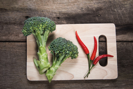 Fresh broccoli and chilli on wood table background. top viewの写真素材