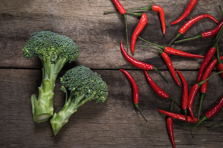 Fresh broccoli and chilli on wood table background. top viewの写真素材