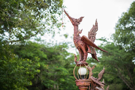 thai bird statue on green background
