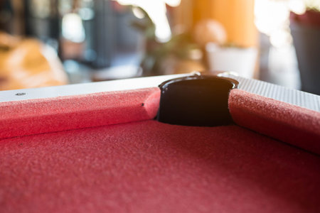 close up of red sanooker table in bokeh background