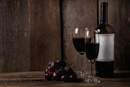 wine and grape on wood table backgroundの写真素材