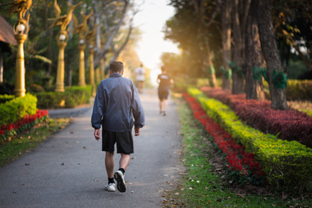 old man walking to exercise in the park