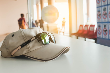 Hat and glasses on white tableの写真素材