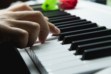 Defocusing hands on the keyboard of the pianoの写真素材