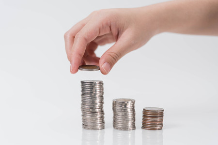 hand putting coin on white background, Saving moneyの写真素材