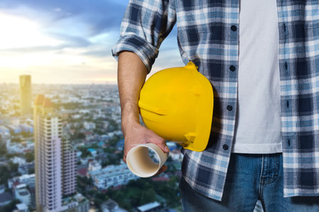engineer holding yellow helmet for workers security