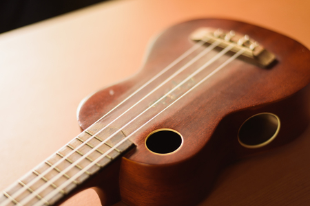 Vintage ukulele on wooden tableの写真素材
